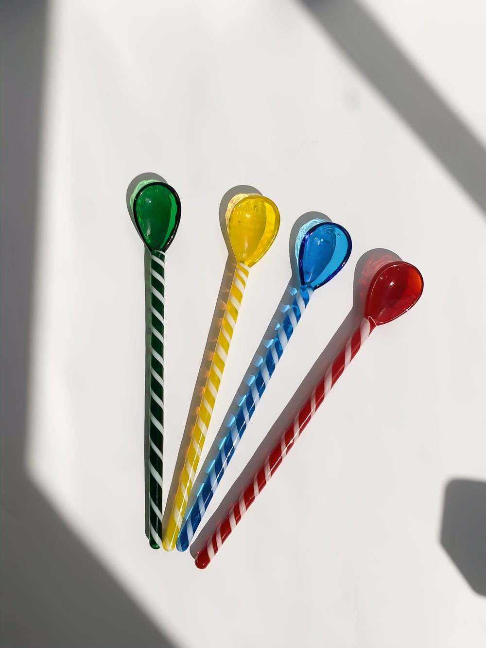 Glass stirrers and spoons in green, yellow, blue and red