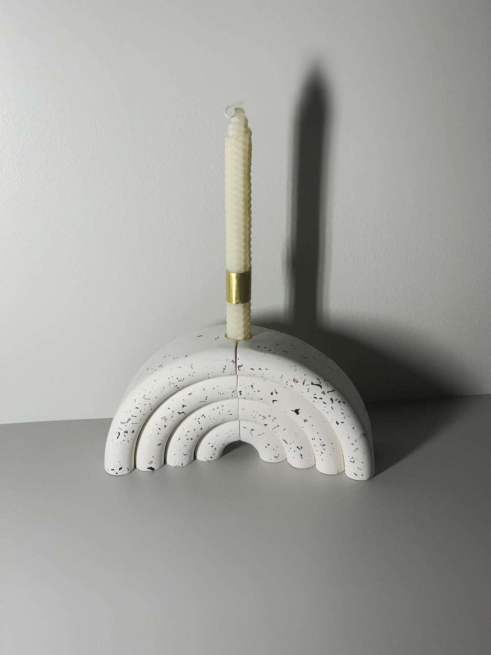 Bokstotto terrazzo bookends holding books on a shelf