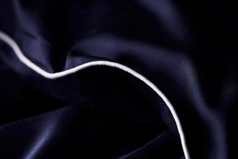 Bamboo lyocell duvet cover set in Jokull navy blue, made up on a bed